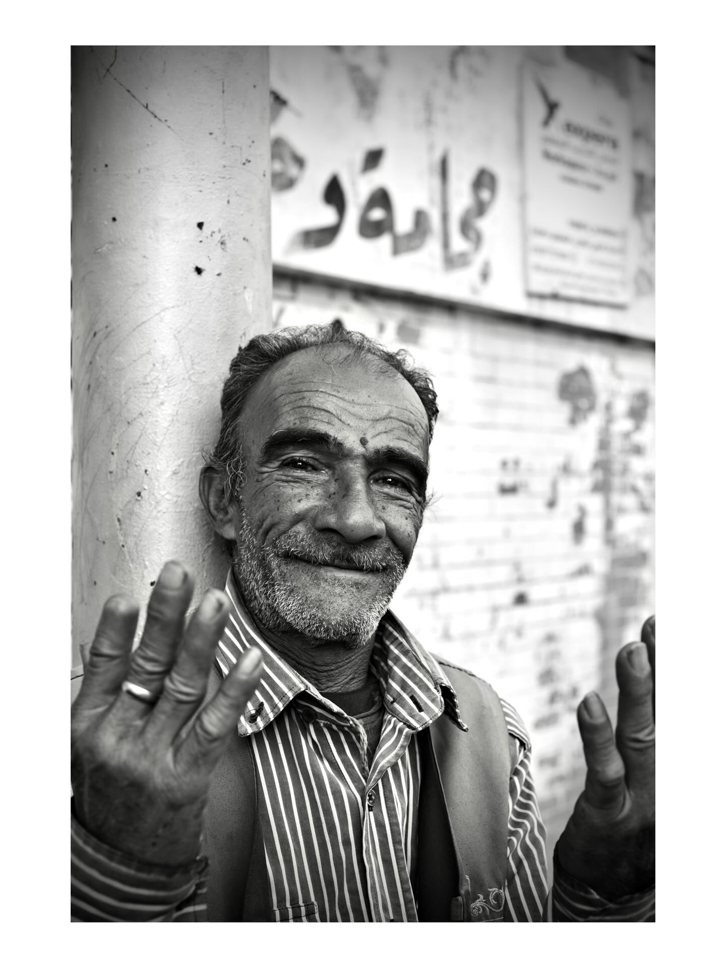 Portrait of a smiling man raising his hands