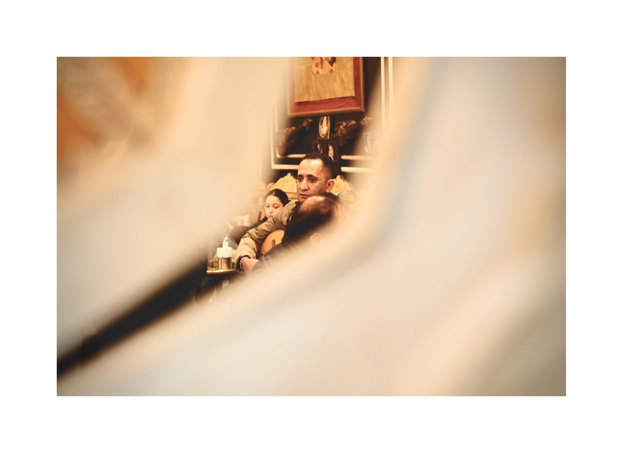 Man framed through foreground fabric