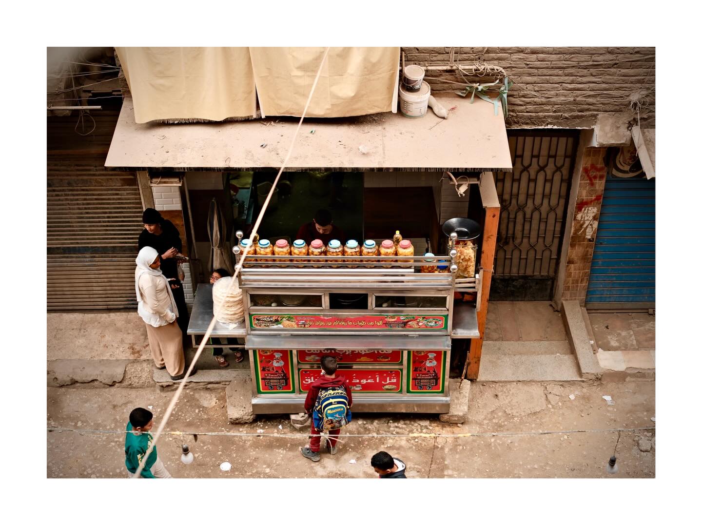 People around a street stall viewed from above