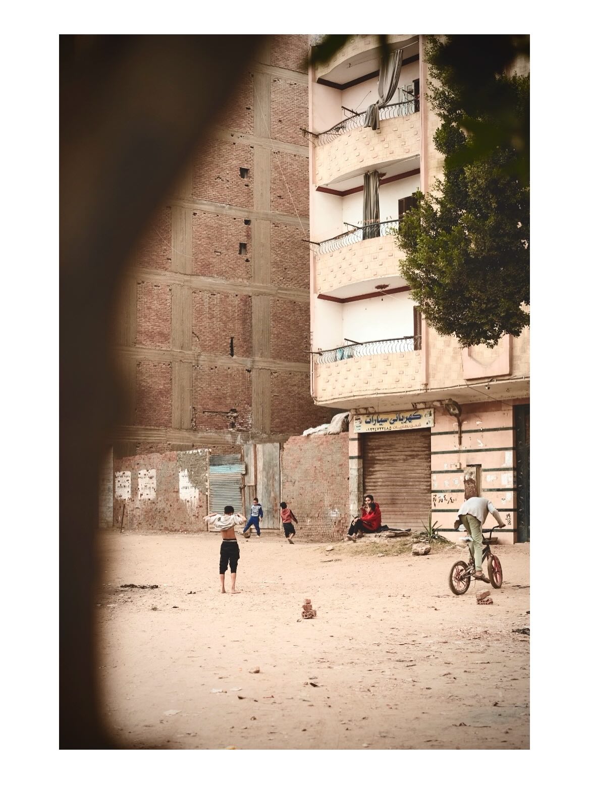 People in an open space between buildings
