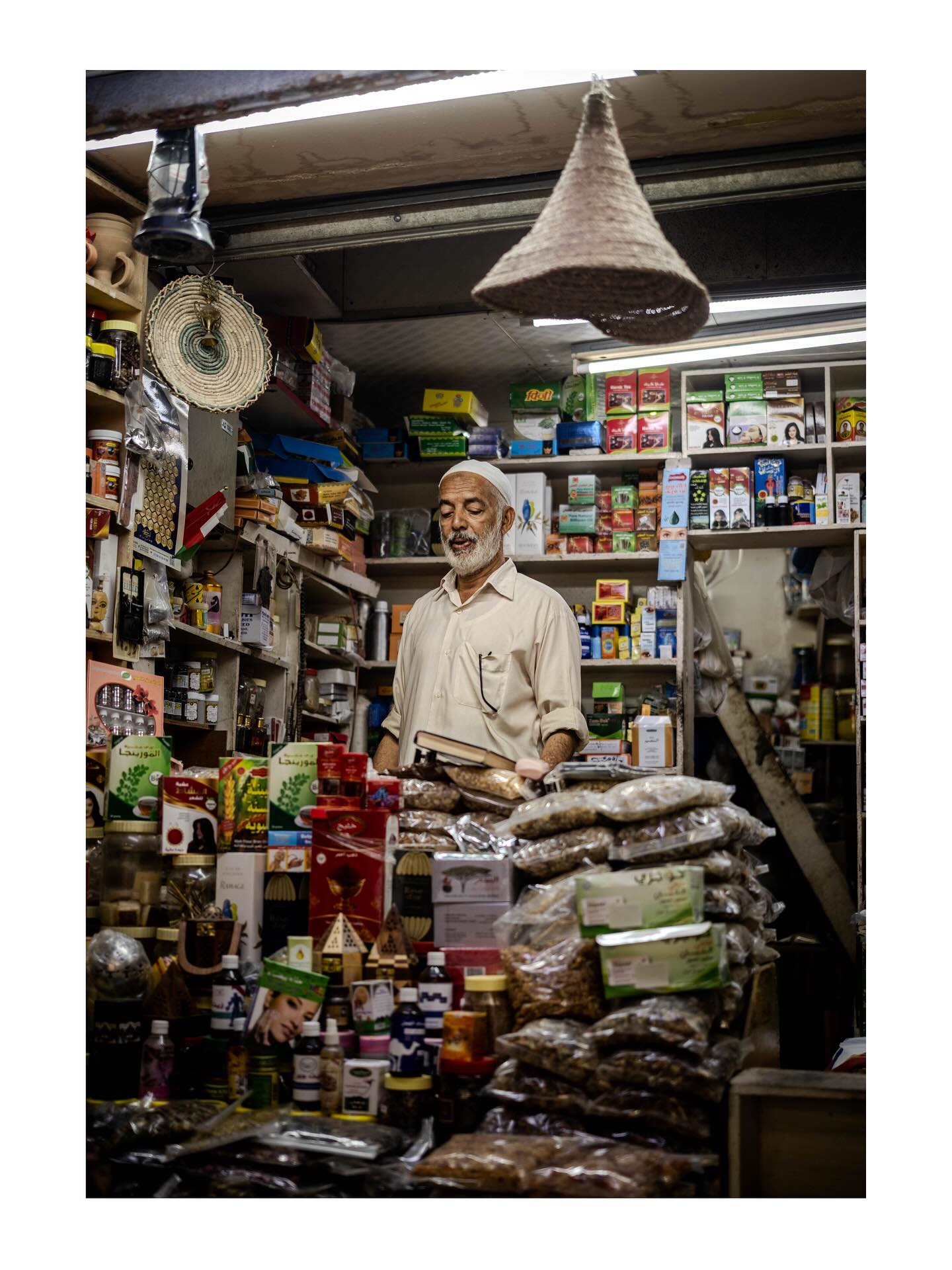 Shopkeeper surrounded by goods