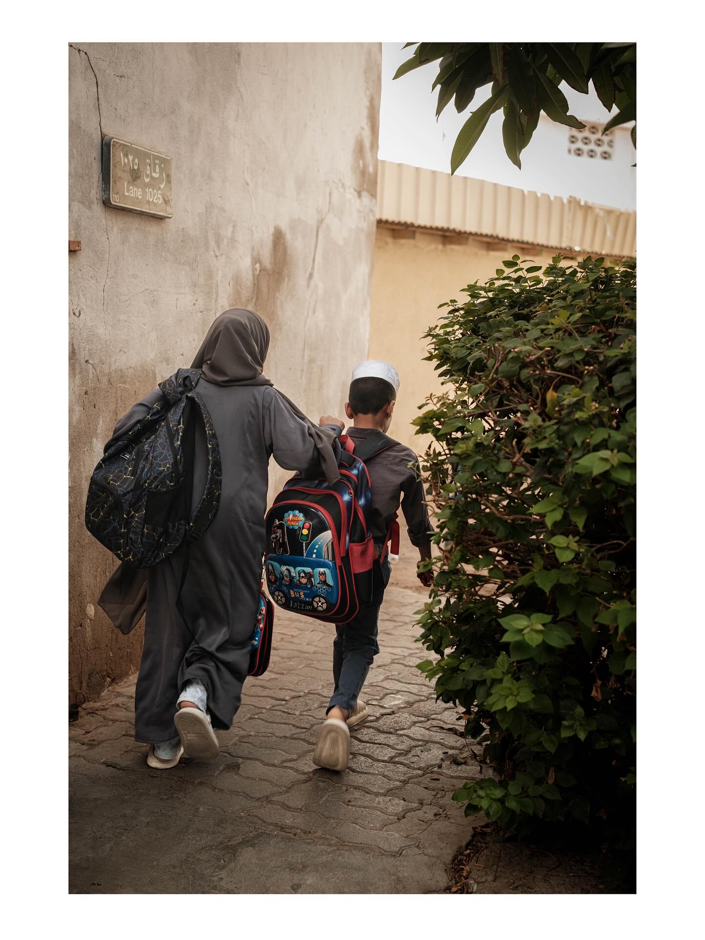 Woman and child walking along a lane