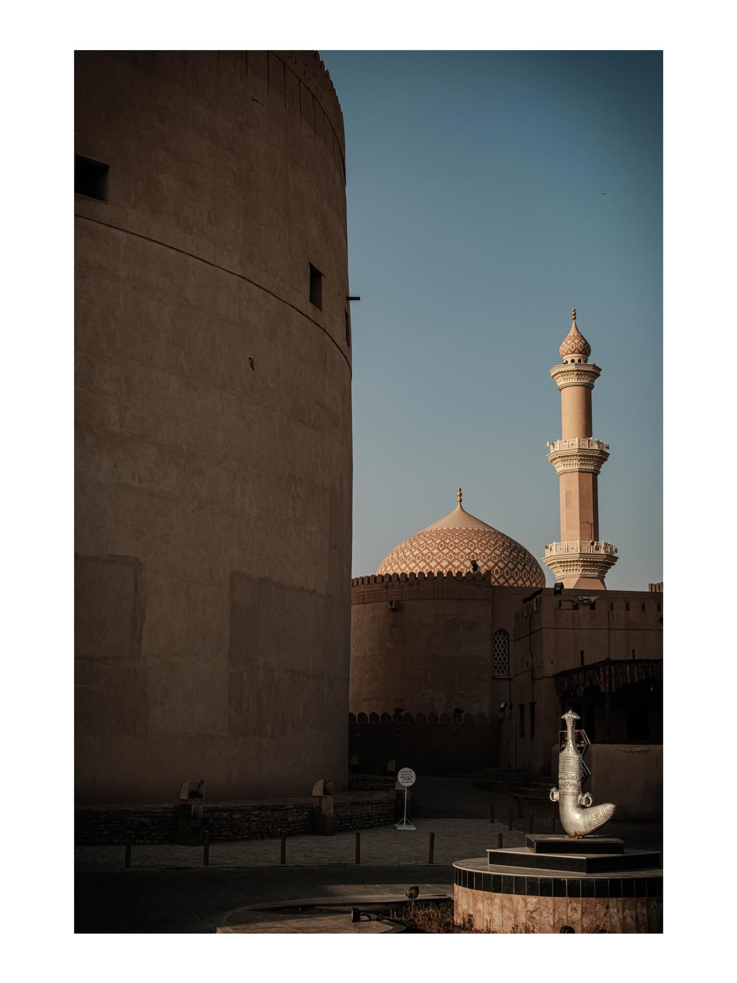 Mosque framed by a curved wall