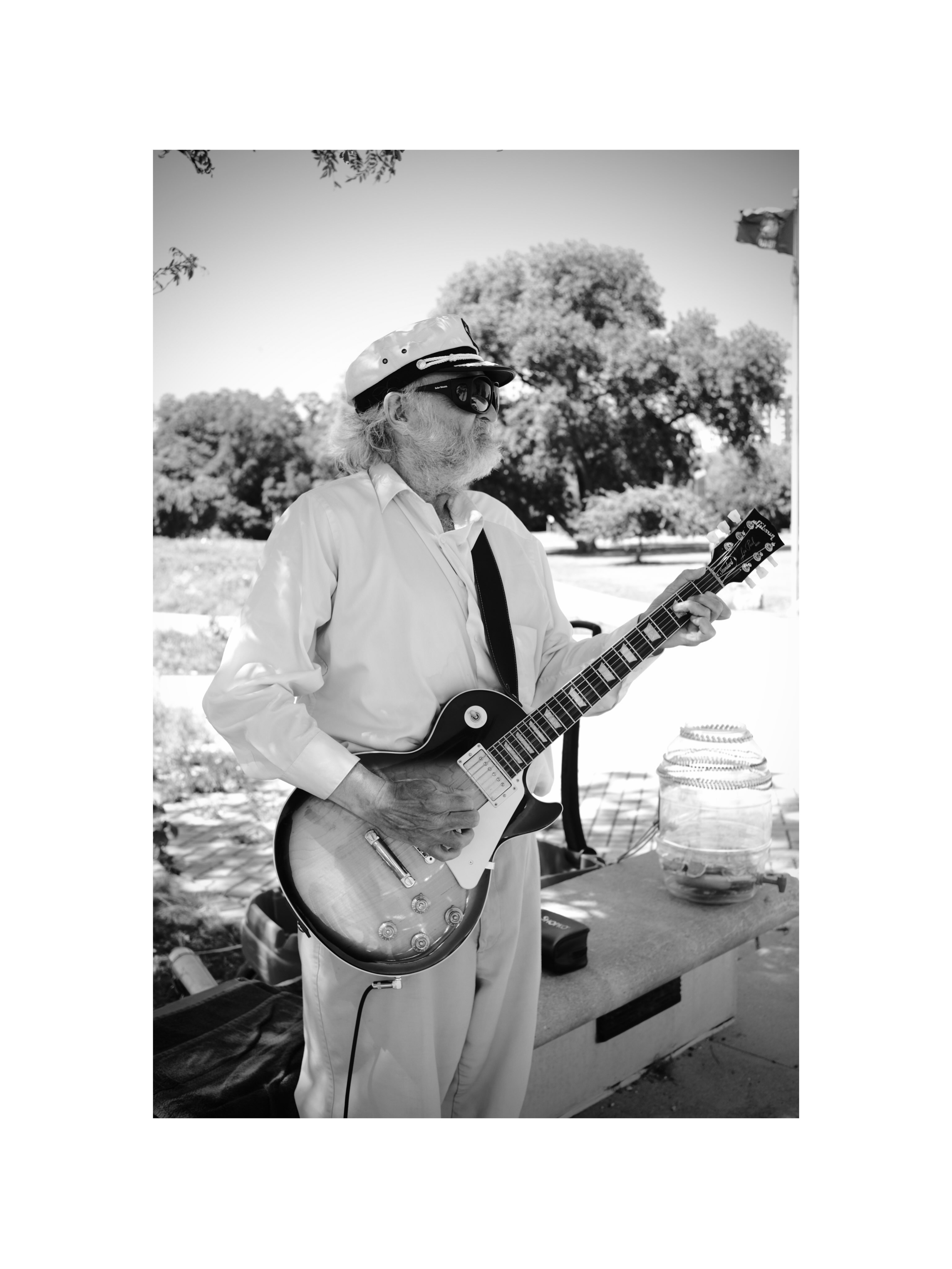 Musician playing guitar outdoors