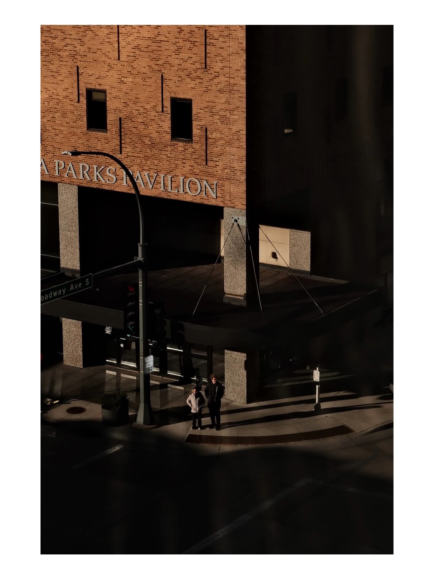 Pedestrians outside a brick corner building